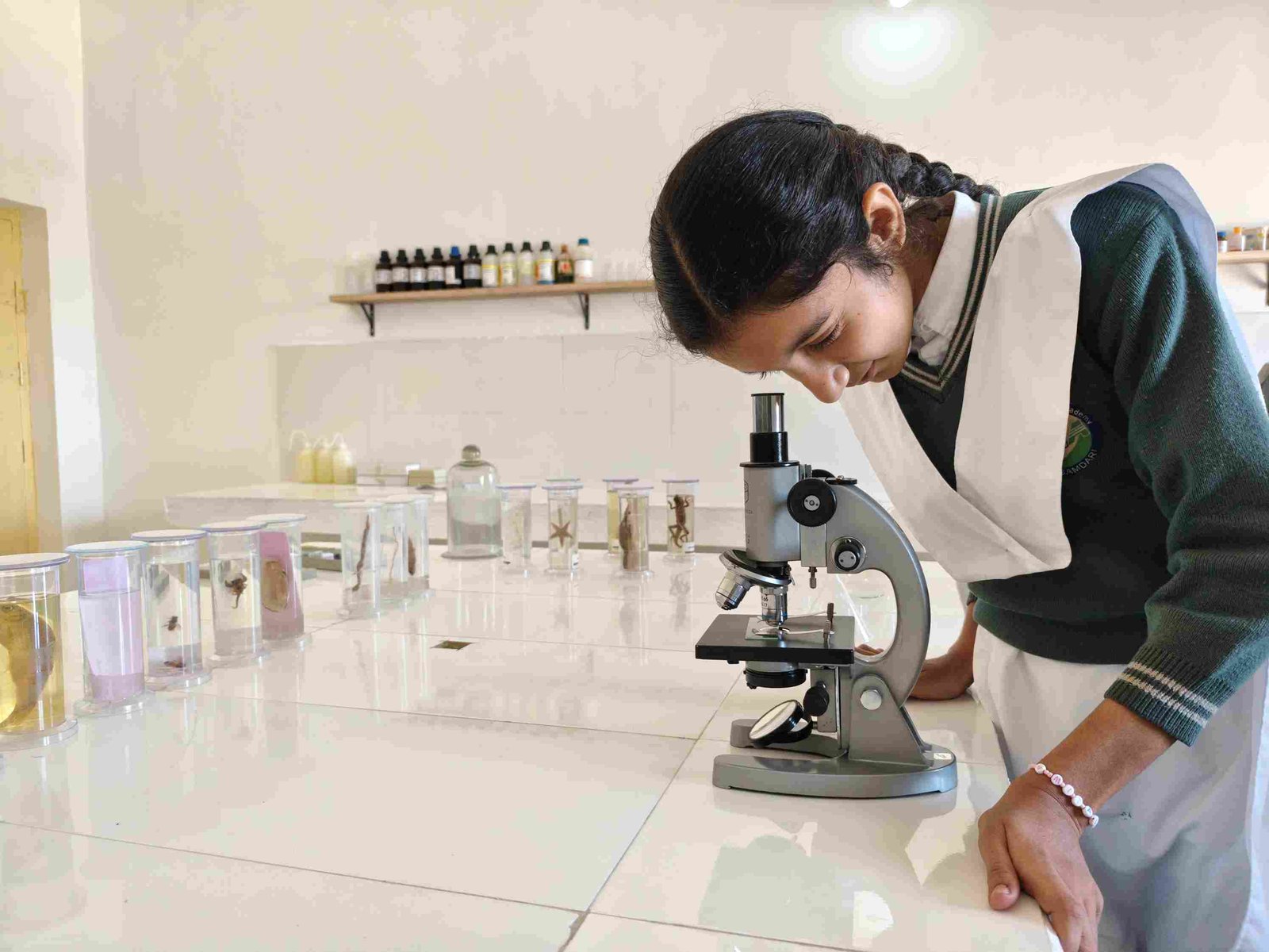 Student using a microscope in the science lab