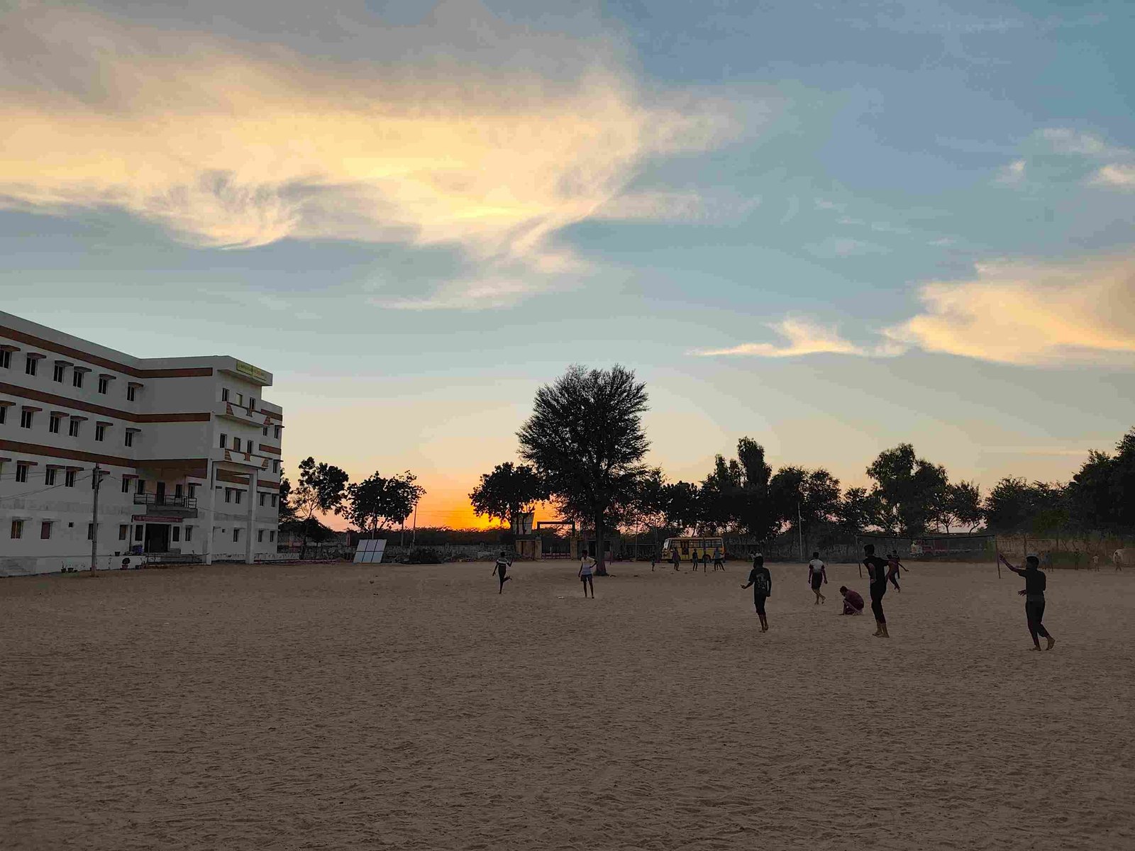 Sunrise Education Academy campus and playground at sunset, Samdari