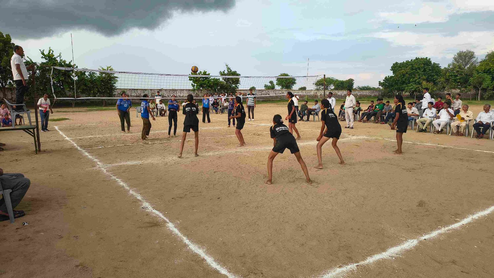 Students playing a volleyball tournament